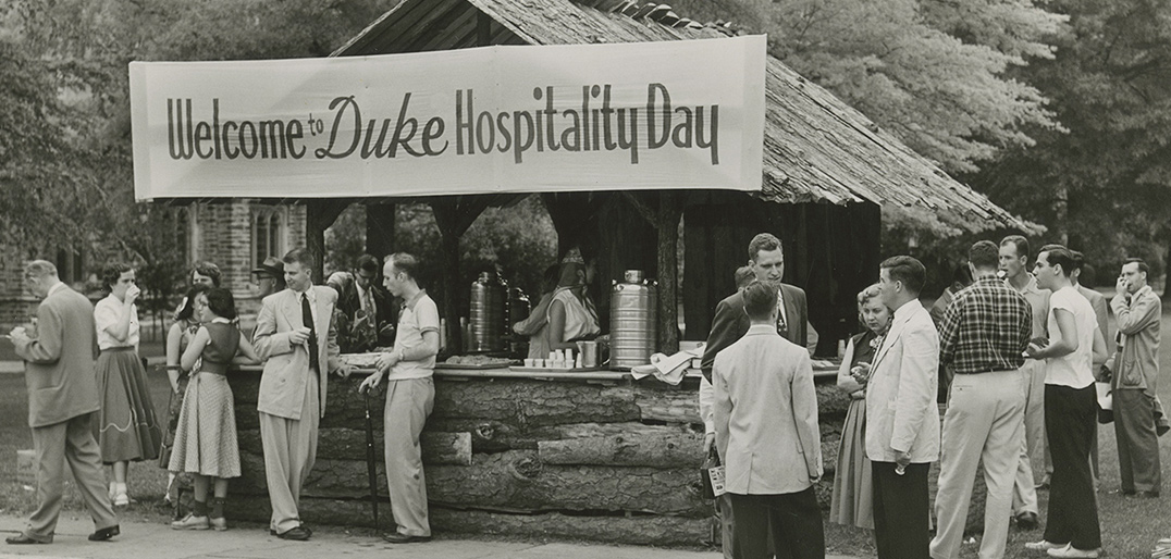 A banner reads 'Welcome to Duke Hospitality Day' while people stand around chatting