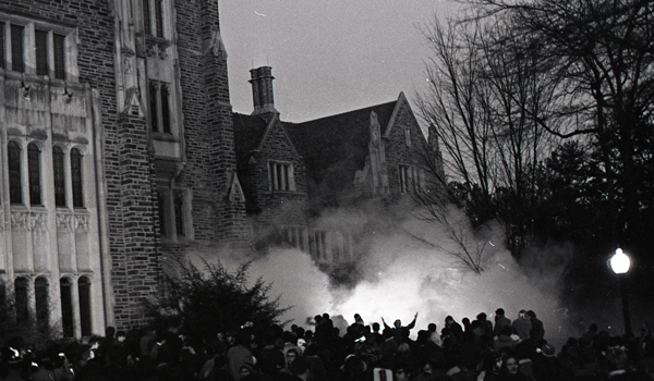 A cloud of tear gas move towards a group student protestors